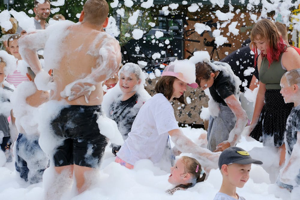 Adults enjoying a foam party with a DJ in Miami