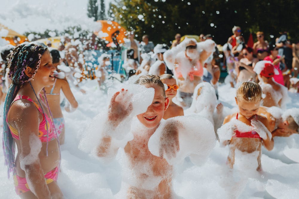 Teenagers throwing foam at a FunLawn foam party